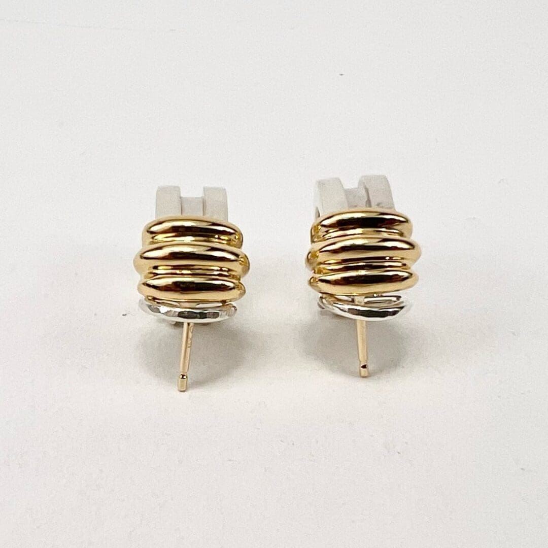 Gold and silver stacked hoop earrings.