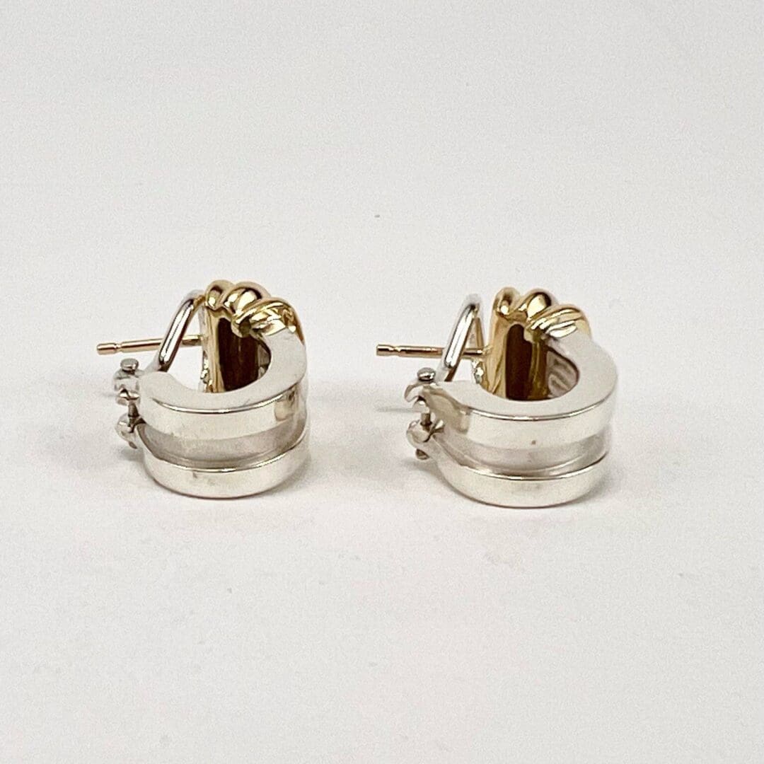 Silver and gold hoop earrings on display.