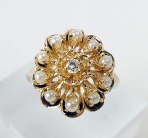 Gold floral ring with pearls and diamond.