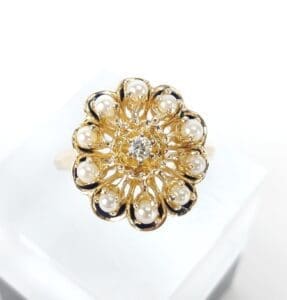 Gold floral ring with pearls and diamond.