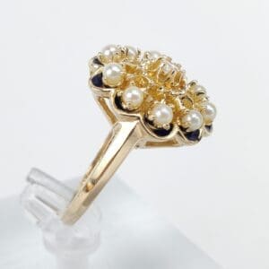 Gold ring with pearls and dark stones.