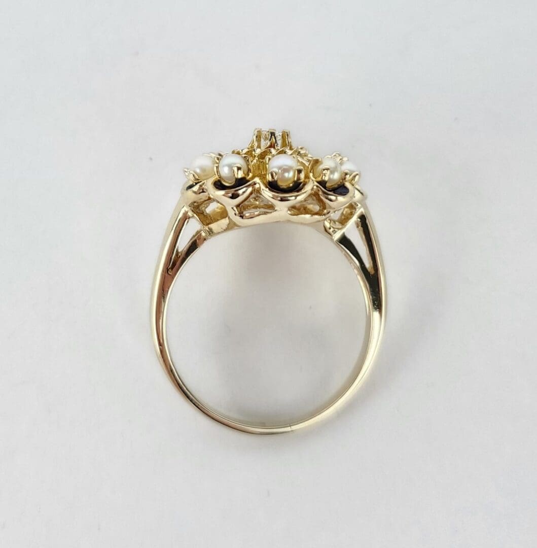 Gold ring with pearls and gemstones.