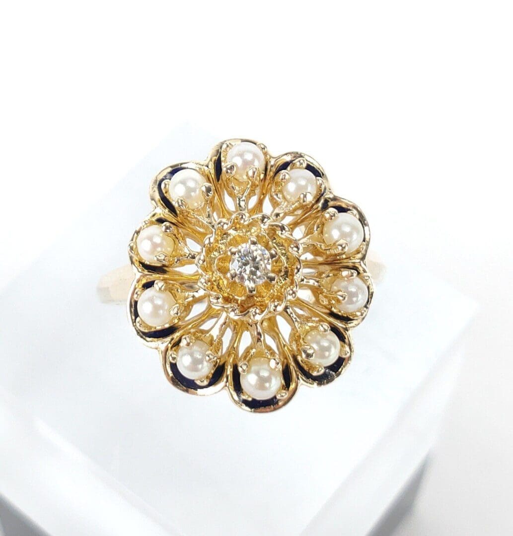 Gold floral ring with pearls and diamond.