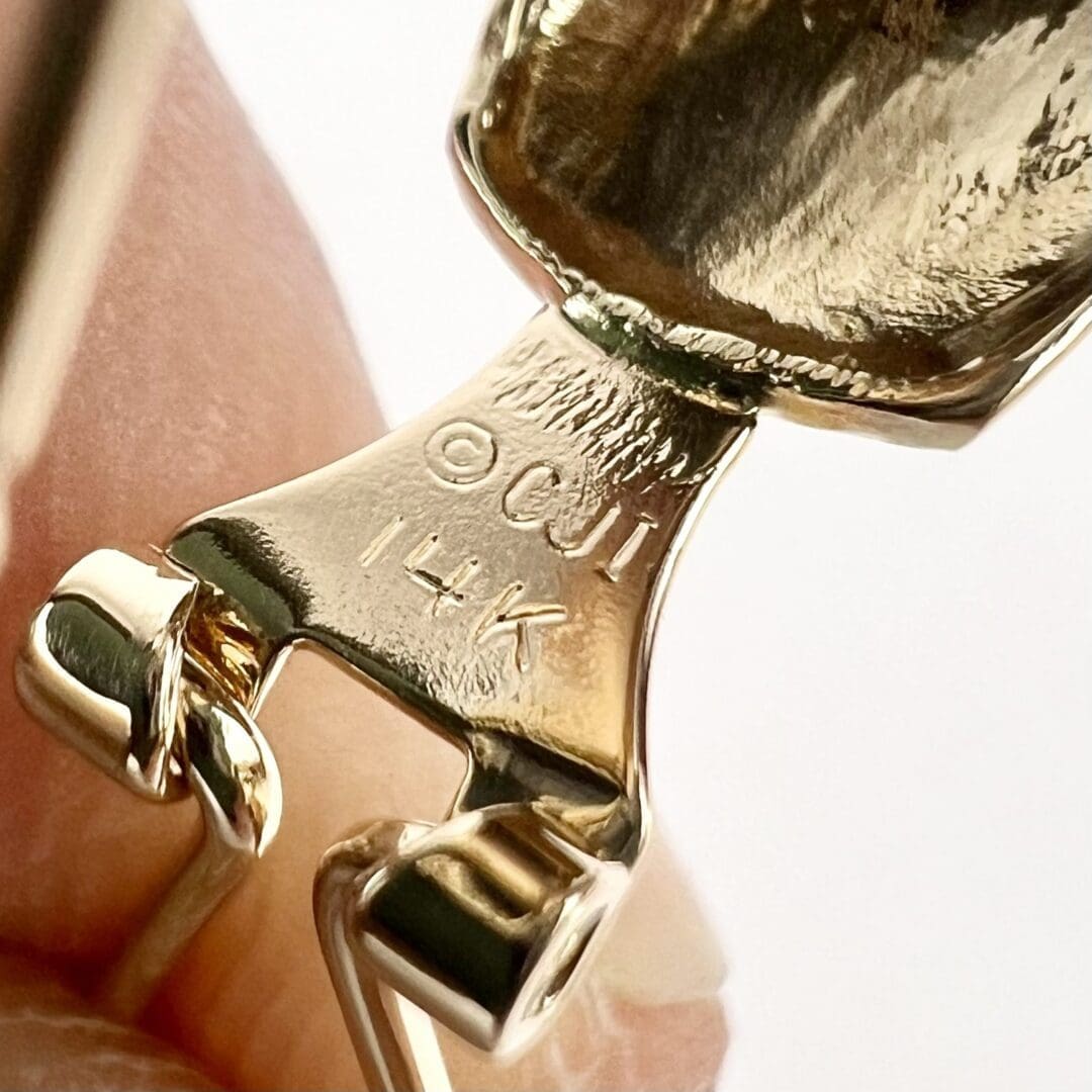 Close-up of 14K gold jewelry hallmark.