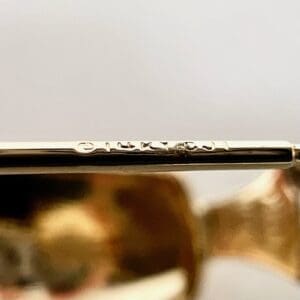 Close-up of engraved text on gold jewelry.