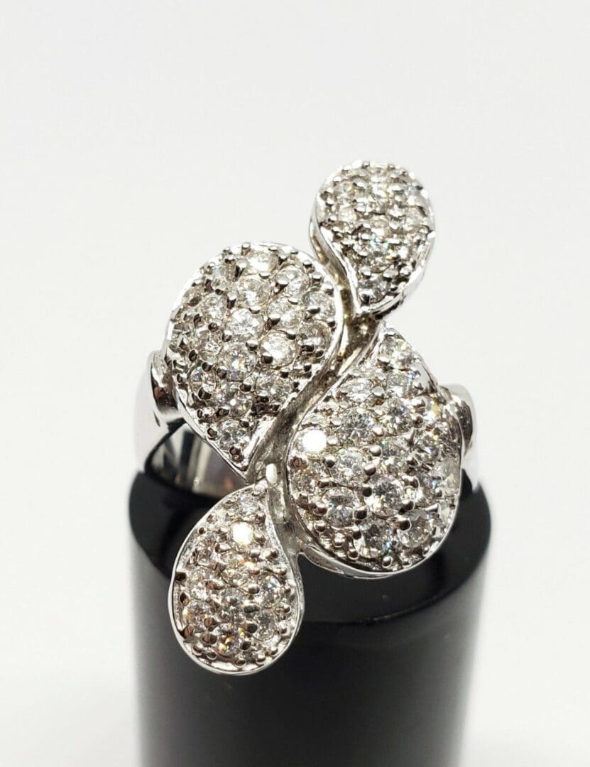 Diamond-studded silver ring with unique design.