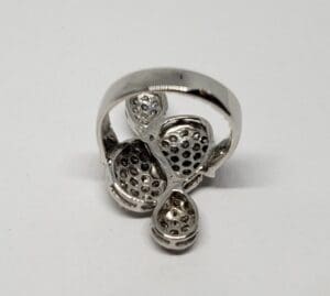 Silver ring with intricate perforated design.