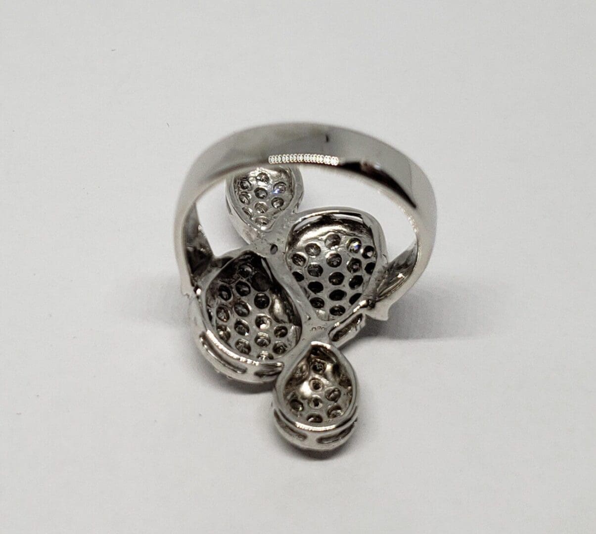 Silver ring with intricate perforated design.