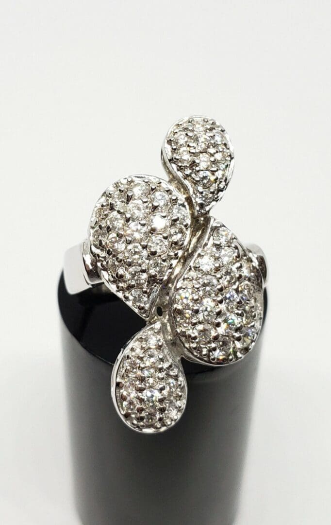 Silver ring with intricate diamond design.