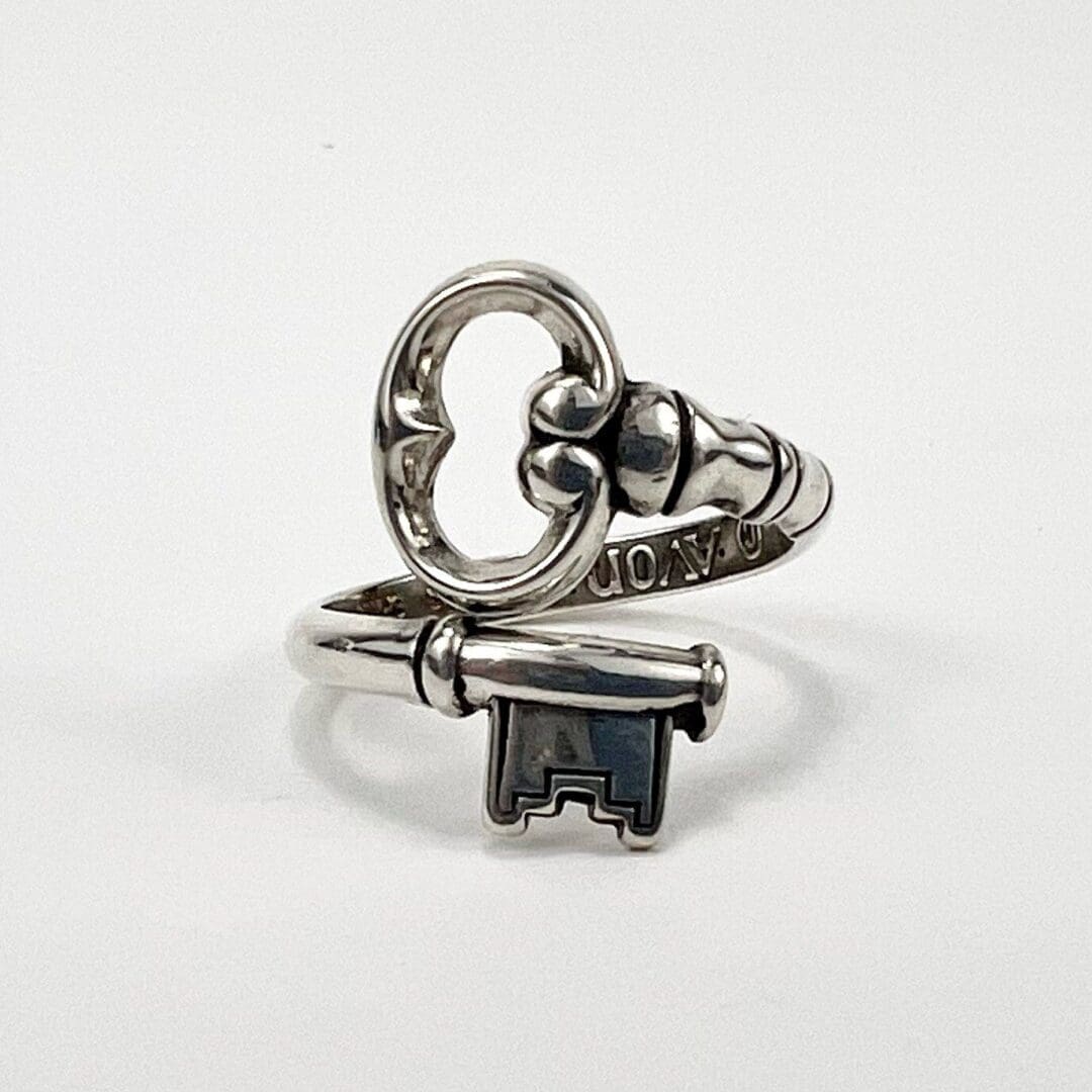 Silver ring with key-shaped design.