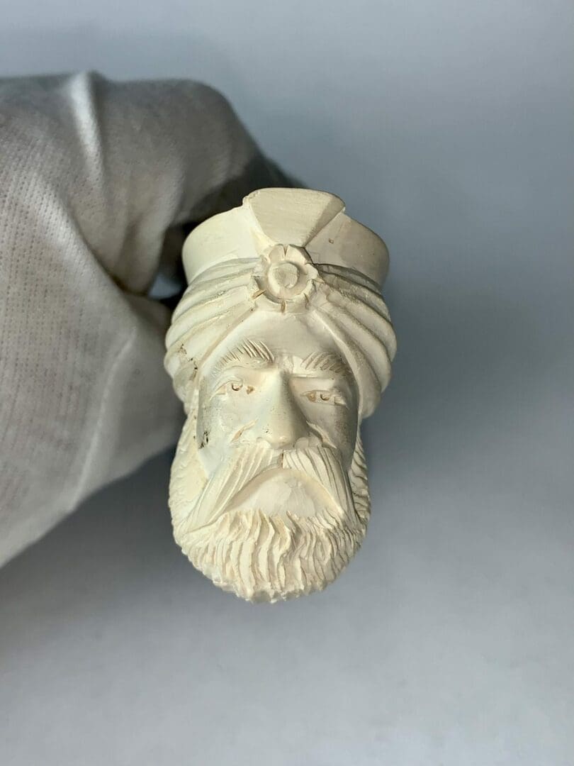 Carved pipe bowl with turbaned figure.