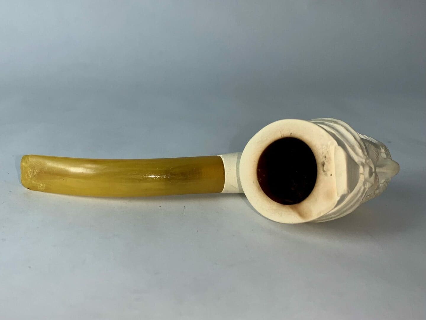 White pipe with yellow stem on table.