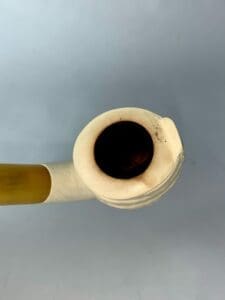 White tobacco pipe with a yellow stem.
