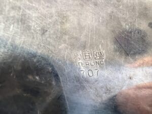 Metal surface stamped with "STERLING 707" text.