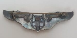 Back view of a silver metal pin.