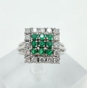Square ring with green and white stones.