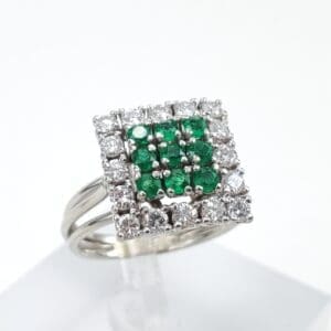 Square diamond ring with green gemstones.