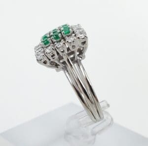 Silver ring with green and clear stones.