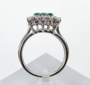 Silver ring with emerald and diamond setting.