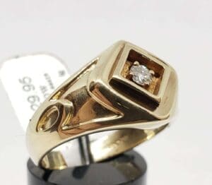 Gold ring with square diamond setting.