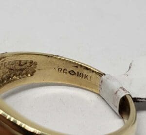 Gold ring with "10KT" engraving inside band.
