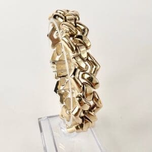 Gold bracelet with unique interlocking design.