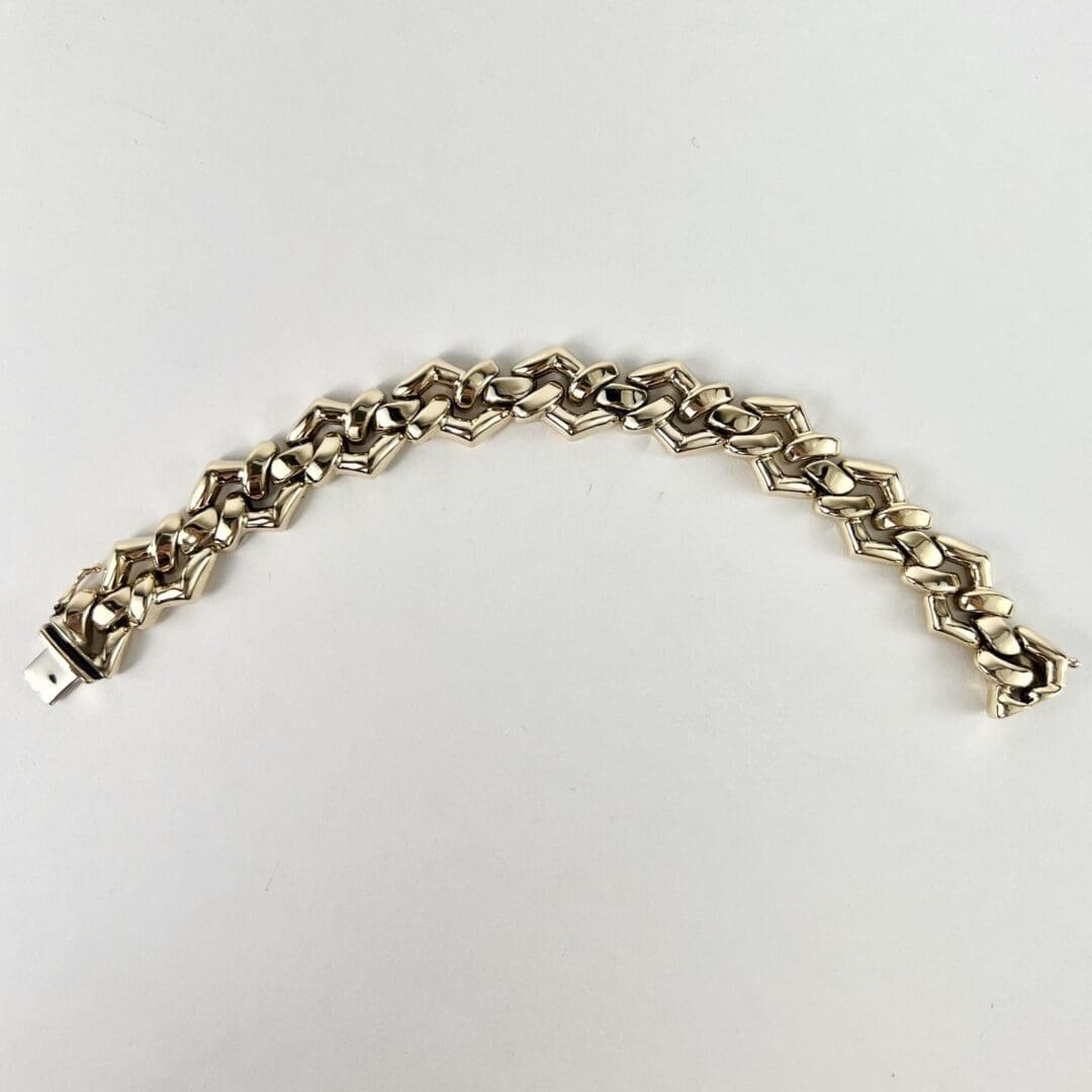 Silver geometric link bracelet on display.