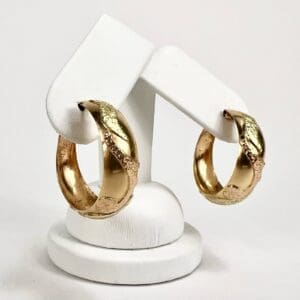 Gold hoop earrings with textured design.