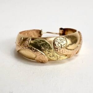 Gold textured bracelet with leaf design.