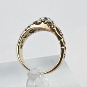 Gold ring with intricate design on display.