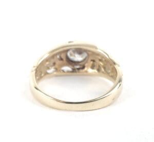 Gold ring with a central gemstone.