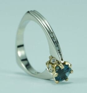 Gold and silver ring with blue gemstone.