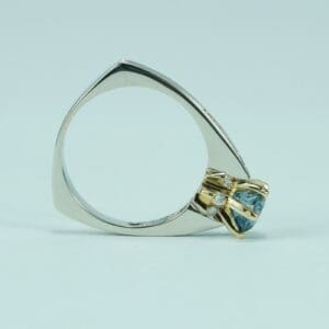 Unique geometric ring with blue gemstone.