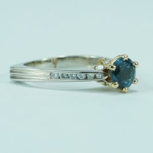 Gold ring with blue gemstone and diamonds.