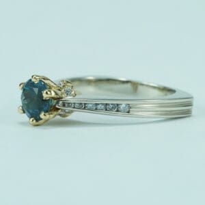 Gold ring with blue gemstone and diamonds.
