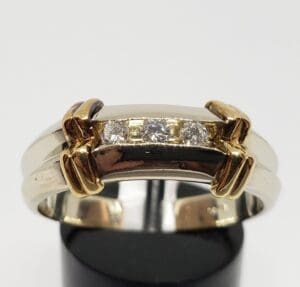 Two-tone ring with embedded diamond stones.