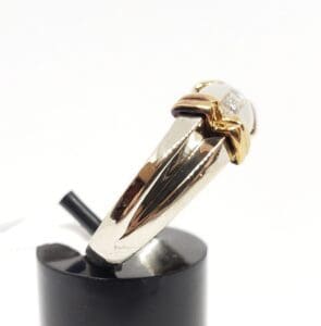 Gold and silver ring on display stand.