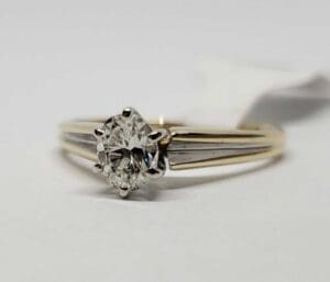 Gold ring with a diamond solitaire.