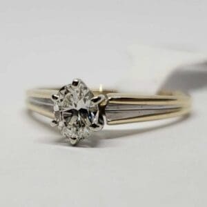 Gold ring with a diamond solitaire.