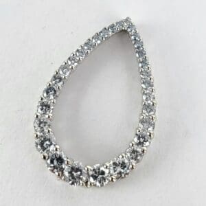 Teardrop-shaped diamond earring on white background.