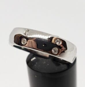 Silver ring with embedded diamond stones.