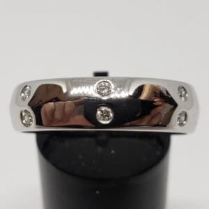 Silver ring with embedded small diamonds.