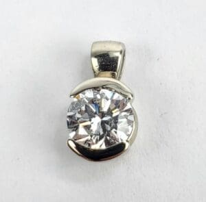 Silver pendant with large round diamond.