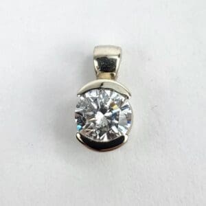 Silver pendant with large round diamond.