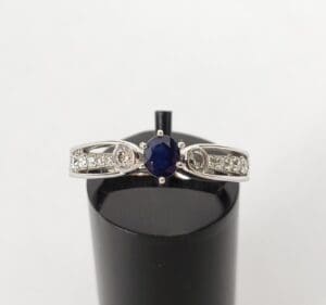 Silver ring with blue center gemstone.