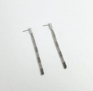 Silver long tassel earrings on white background.