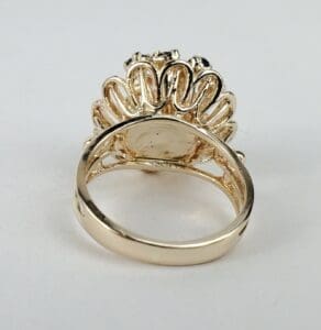Gold ring with intricate floral design.