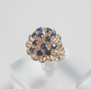 Gold ring with blue gemstone cluster.