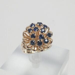 Gold ring with blue gemstone cluster.