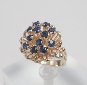 Gold ring with blue gemstones cluster.